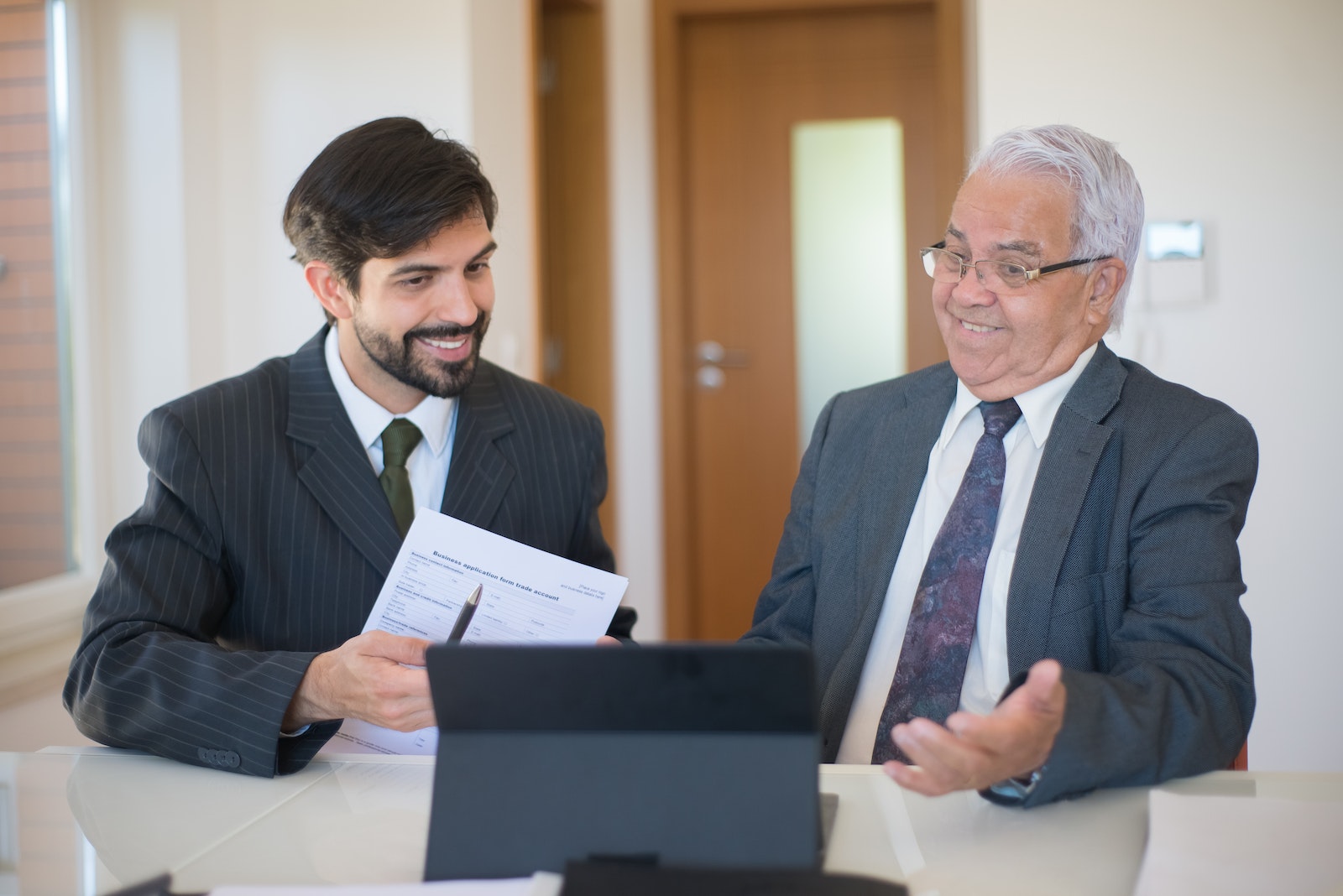 Salesman Discussing Real Estate to a Senior Man